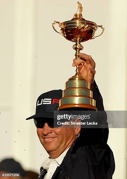 Captain Davis Love III of the United States holds the Ryder Cup at the colsing ceremonies after defeating Europe during singles matches of the 2016...