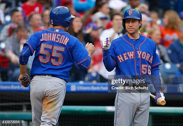 Kelly Johnson of the New York Mets is congratulated by Ty Kelly after scoring on an RBI double by Kevin Plawecki against the Philadelphia Phillies...