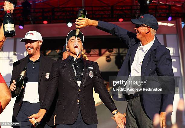 Vice-captain Tom Lehman pours champagne on Rickie Fowler of the United States during the closing ceremony of the 2016 Ryder Cup at Hazeltine National...