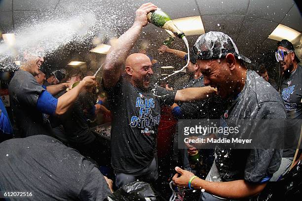 Ryan Goins of the Toronto Blue Jays sprays Ezequiel Carrera with champagne to celebrate their 2-1 win over the Boston Red Sox, clinching a Wildcard...