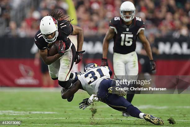 Wide receiver Larry Fitzgerald of the Arizona Cardinals rushes the football against free safety Maurice Alexander of the Los Angeles Rams during the...