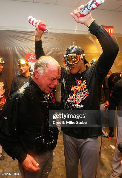 Manny Machado and Buck Showalter of the Baltimore Orioles celebrates after defeating the New York Yankees to clinch AL Wild Card spot at Yankee...