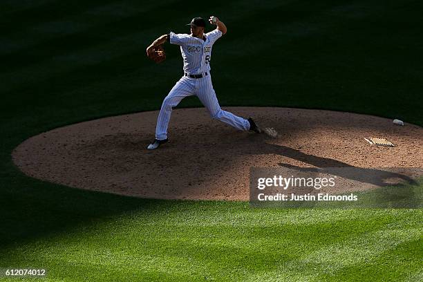 Relief pitcher Chris Rusin of the Colorado Rockies delivers to home plate during the ninth inning against the Milwaukee Brewers at Coors Field on...