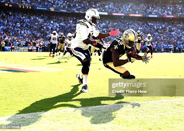 Michael Thomas of the New Orleans Saints makes a catch for a touchdown in front of Pierre Desir of the San Diego Chargers to trail 28-34 during the...