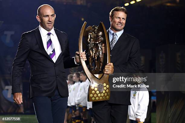 Matt Geyer and Andrew Ettingshausen carry the Premiership trophy before the 2016 NRL Grand Final match between the Cronulla Sharks and the Melbourne...