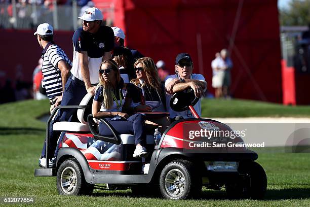 Jimmy Walker, Erin Walker, Tabitha Furyk and vice-captain Jim Furyk of the United States look on during singles matches of the 2016 Ryder Cup at...