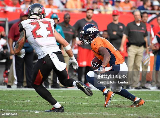 Denver Broncos wide receiver Jordan Norwood turns up field as Tampa Bay Buccaneers strong safety Chris Conte moves in for the tackle during the...