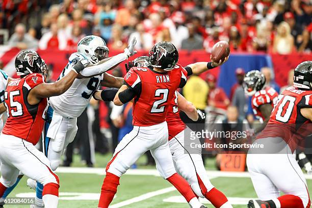 Atlanta Falcons quarterback Matt Ryan throws the ball under pressure during the first half of the NFL game between the Carolina Panthers and the...