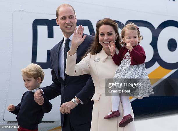 Prince William, Duke of Cambridge, Prince George of Cambridge, Catherine, Duchess of Cambridge and Princess Charlotte wave as they leave from...