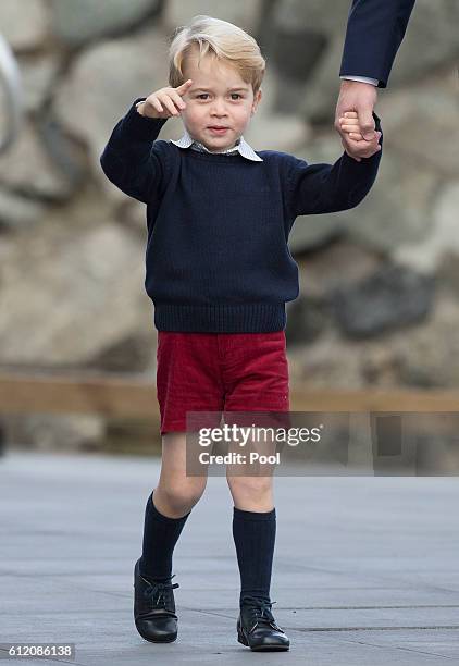 Prince George of Cambridge waves as he leaves from Victoria Harbour to board a sea-plane on the final day of their Royal Tour of Canada on October 1,...