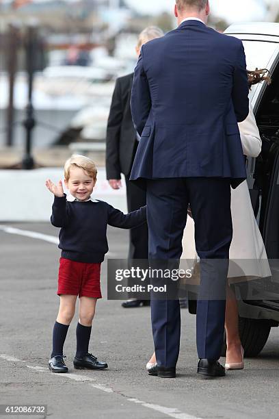 Prince George of Cambridge waves as he leaves from Victoria Harbour to board a sea-plane on the final day of their Royal Tour of Canada on October 1,...