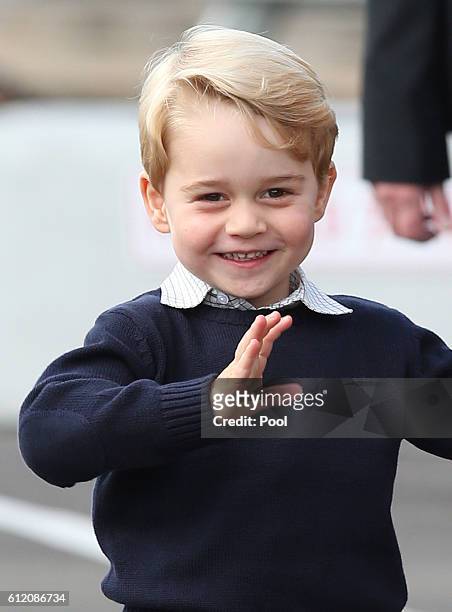 Prince George of Cambridge waves as he leaves from Victoria Harbour to board a sea-plane on the final day of their Royal Tour of Canada on October 1,...