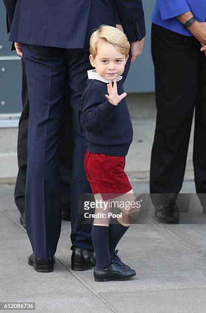 Prince George of Cambridge waves as he leaves from Victoria Harbour to board a sea-plane on the final day of their Royal Tour of Canada on October 1,...