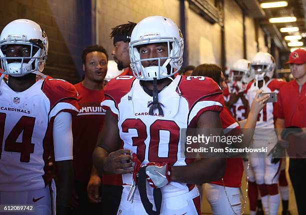 Stepfan Taylor of the Arizona Cardinals and teammates walk out onto the field through the tunnel before the start of NFL game action against the...