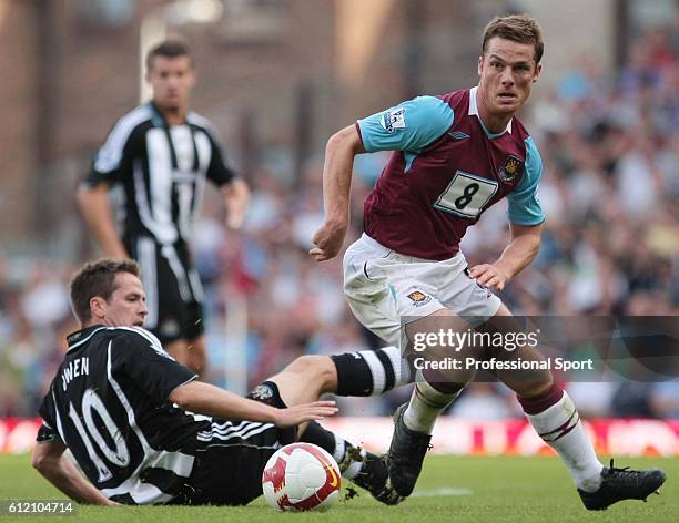 Michael Owen of Newcastle slides in on Scott Parker of West Ham United during the Barclays Premier League match between West Ham United and Newcastle...