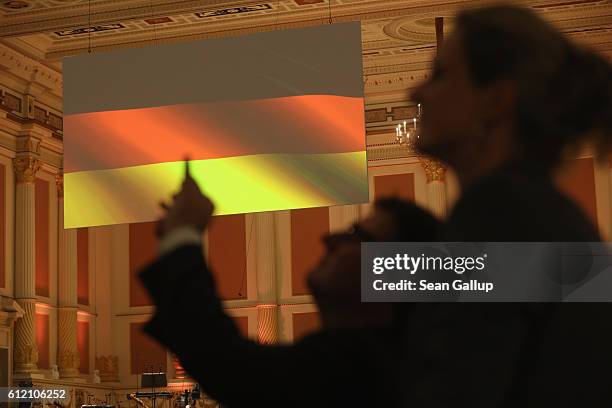 German flag hangs as guests arrive for celebrations to mark German Unity Day at the Semperoper opera house on October 3, 2016 in Dresden, Germany....