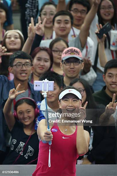 Shuai Peng of China takes a selfie with fans after wining the Women's singles first round match against Venus Williams of USA on day three of the...