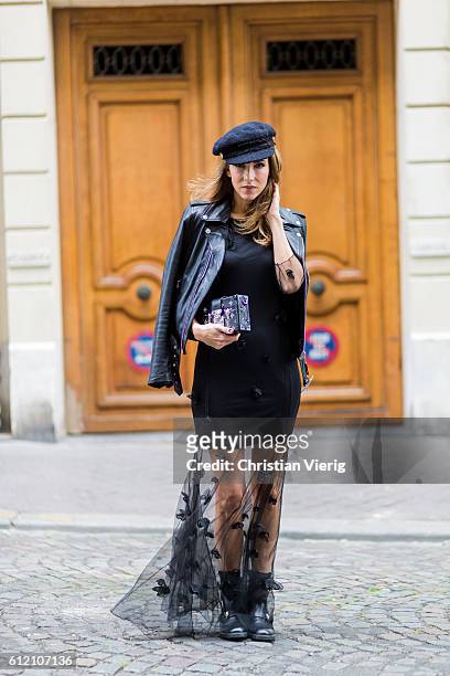 Fashion blogger and model Alexandra Lapp wearing a black sheer dress from Patrizia Pepe, Schott NYC bomber jacket, Gucci boots, Chanel hat, Louis...