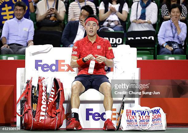 Kei Nishikori of Japan is seen resting during the men's singles first round match against Donald Young of USA on day one of Rakuten Open 2016 at...