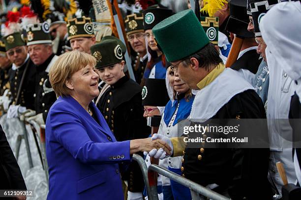 German Chancellor Angela Merkel greets visitors before the ceremony for celebrations to mark German Unity day on October 3, 2016 in Dresden, Germany....