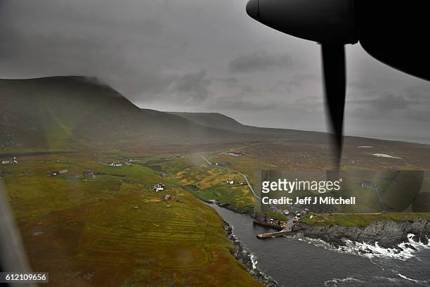The plane arrives from Tingwall airport at the Island of Foula airstrip on September 28, 2016 in Foula, Scotland. Foula is the remotest inhabited...