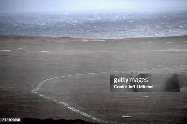 Rain moves across the main arterial road on the Island of Foula on September 29, 2016 in Foula, Scotland. Foula is the remotest inhabited island in...