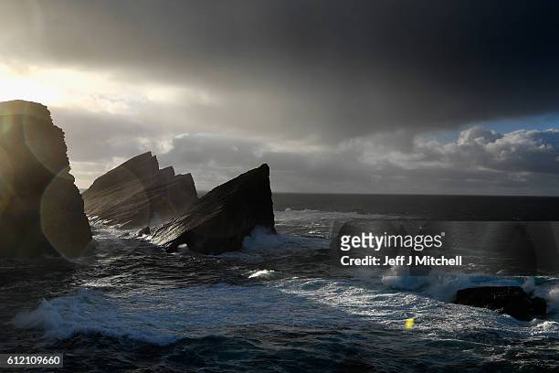 Sunlight shines through the cliffs on the Island of Foula on September 30, 2016 in Foula, Scotland. Foula is the remotest inhabited island in Great...