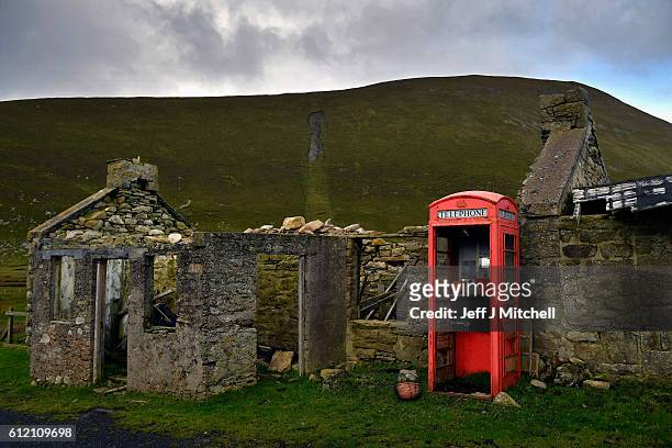 Building and telephone box on the Island of Foula on September 29, 2016 in Foula, Scotland. Foula is the remotest inhabited island in Great Britain...