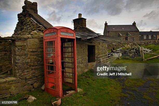 Building and telephone box on the Island of Foula on September 29, 2016 in Foula, Scotland. Foula is the remotest inhabited island in Great Britain...