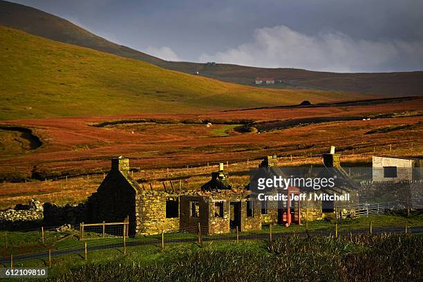 View of a disused cottage and telephone box on the Island of Foula on September 29, 2016 in Foula, Scotland. Foula is the remotest inhabited island...