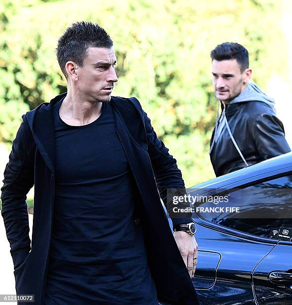 France's defender Laurent Koscielny and goalkeeper Hugo Lloris arrive at the French national football team training base in Clairefontaine on October...