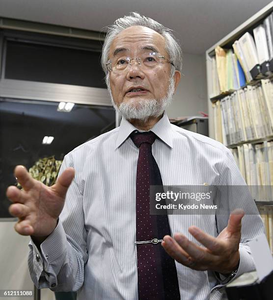 Yoshinori Osumi, a Tokyo Institute of Technology professor emeritus, speaks to reporters at the university's campus in Yokohama on Oct. 3 after...