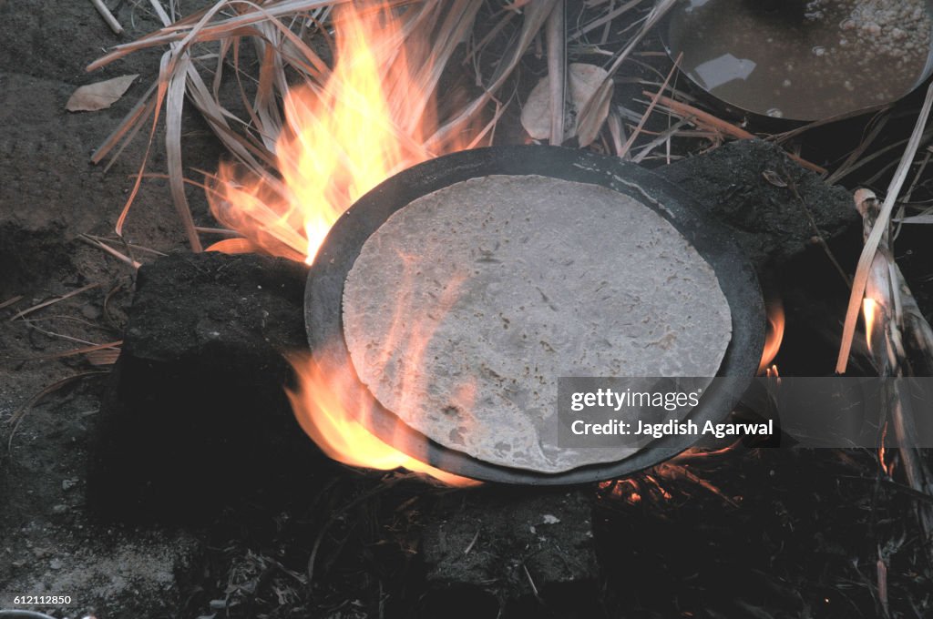 Roti roasted on pan kept over fire