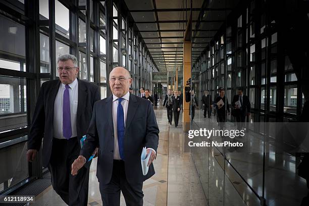 French Finance Minister Michel Sapin and Budget Junior Minister Christian Eckert attend a press conference to present the French government's...