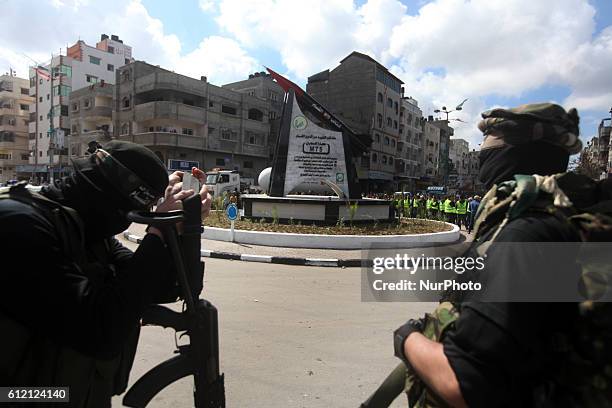 Militants in front of the monument of a homemade M75 rocket in the middle of a square in Gaza City March 10, 2014. Hamas fired M75 rockets at Tel...