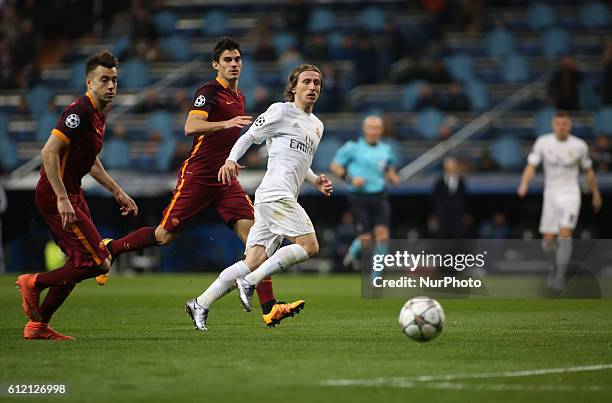 Luka Modric of Real Madrid in action against El Shaarawy an Perotti of AS Roma during the UEFA Champions League Round of 16 Second Leg match between...