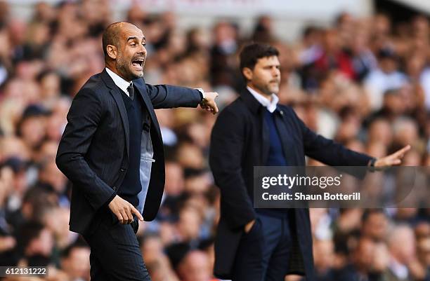 Josep Guardiola, Manager of Manchester City reacts next to Mauricio Pochettino, manager of Tottenham Hotspur during the Premier League match between...