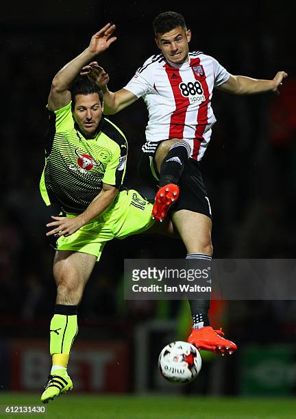 John Egan of Brentford tries to tackle Yann Kermorgant of Reading during the Sky Bet Championship match between Brentford and Reading at Griffin Park...