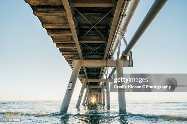 southport sandpumping jetty at sunrise - smooth sunstar stock pictures, royalty-free photos & images
