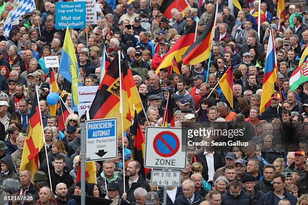 Supporters of the Pegida movement carrying German flags gather to march on German Unity Day on October 3, 2016 in Dresden, Germany. Unity Day, called...