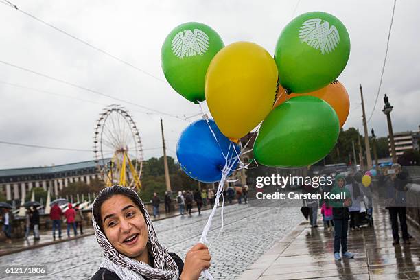 Woman holds balloons during the celebrations to mark German Unity day on October 3, 2016 in Dresden, Germany. Unity Day, called Tag der Deutschen...