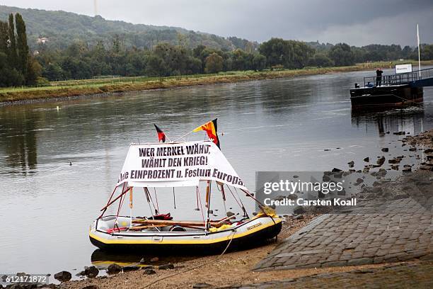 Banner with the slogan "Wer Merkel waehlt, waehlt den Krieg" is fixed on a boat during a ralley of right wing citizens movement "Festung Europa" on...