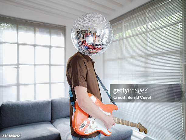 man standing behind disco ball - boygroup stock-fotos und bilder