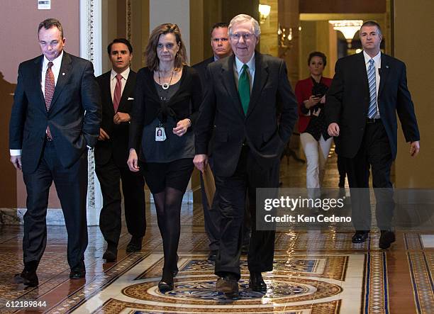 Minority Leader Senator Mitch McConnell walks to the Senate floor with his staff to consider a possible deal to prevent the 'fiscal cliff', on...