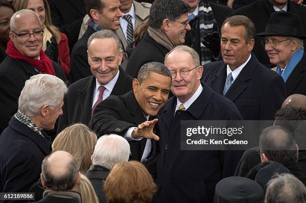 President Barack Obama salutes waves to invited guests during the 57th Inauguration on the West Front of the US Capitol for his swearing in ceremony...