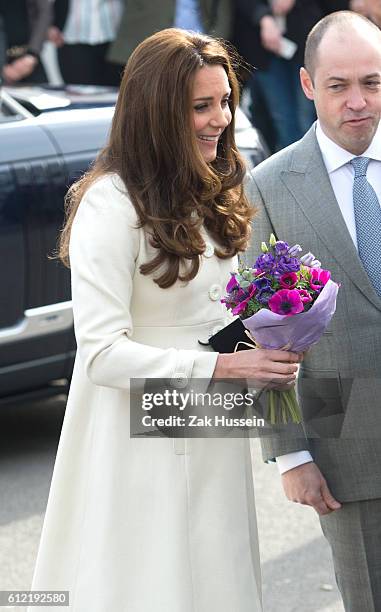 Catherine, Duchess of Cambridge, wearing a cream Jojo Maman Bebe maternity coat, visits cast and crew of Downton Abbey at Ealing Studios in London.