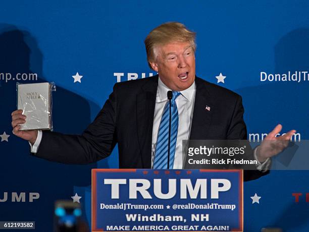 Republican Presidential candidate Donald Trump holding a bible, given to him by a supporters at a campaign rally at The Castelton Banquet &...