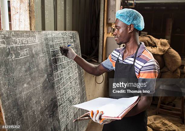 Mim, Ghana A warehouse worker of the MIM cashew processing company is listing the inventory on a chalkboard on September 07, 2016 in Mim, Ghana.