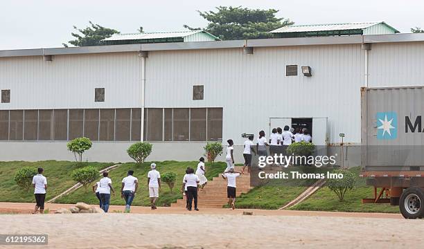 Mim, Ghana African men and women on their way to the MIM cashew processing company on September 07, 2016 in Mim, Ghana.