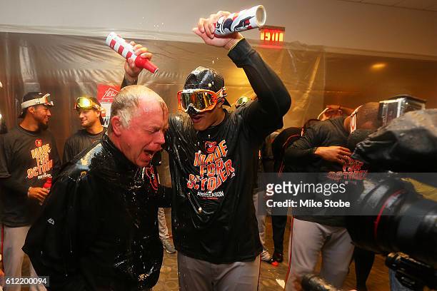 Manny Machado and Buck Showalter of the Baltimore Orioles celebrates after defeating the New York Yankees to clinch AL Wild Card spot at Yankee...
